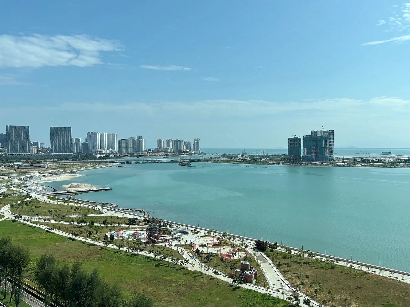 Commercial real estate waterfront city scape with modern buildings and clear blue sky.