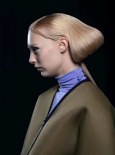 Woman wearing green jacket with gorgeous hair.