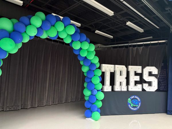 Balloon arch and IRES sign at a school event.