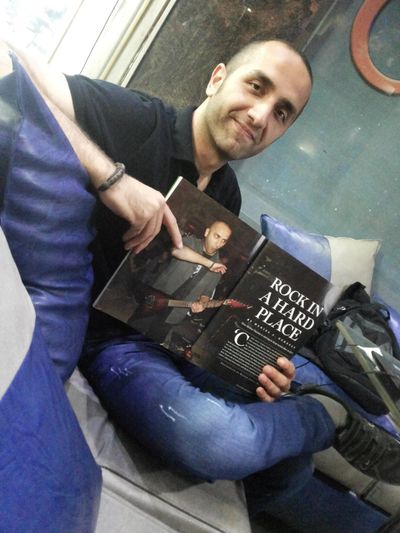 Bashar Haroun holding a copy of the Rolling Stone magazine with him featured on the pages