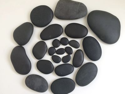 Spiral of smooth, basalt stones used during Hot Stones Reflexology