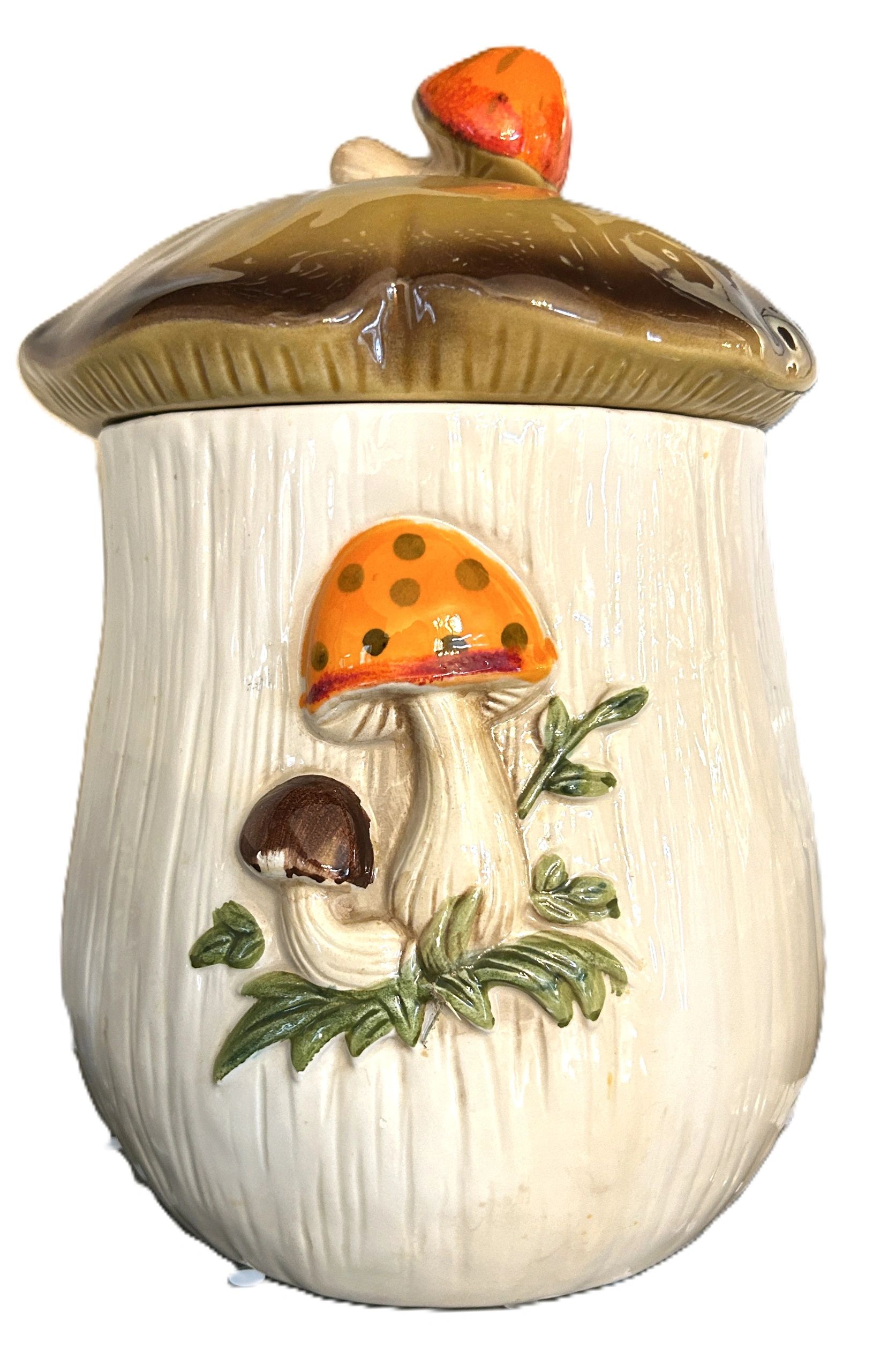 Ceramic jar with mushroom designs and a textured lid.