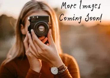 Person holding a camera with text 'More Images Coming Soon!' in the background.