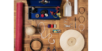 Various sewing and crafting supplies neatly arranged on a wooden table.