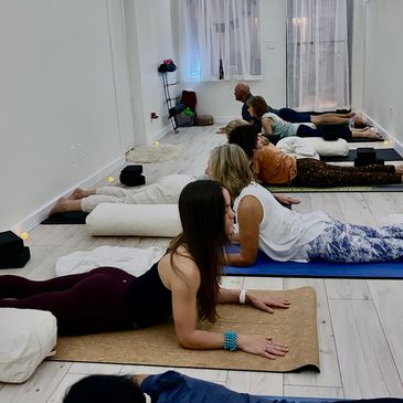 People doing sphinx pose on yoga mats