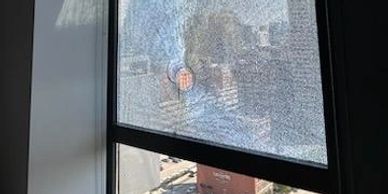 Damaged condo window. 24 hour emergency board up service.