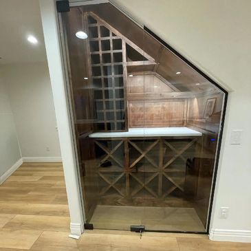 Custom interior glass wall. Wine room glass panel wall.