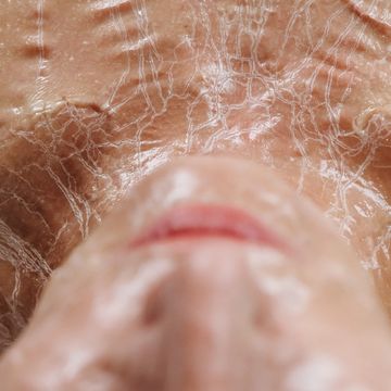 Close-up of a face with a cracked, dried texture effect.