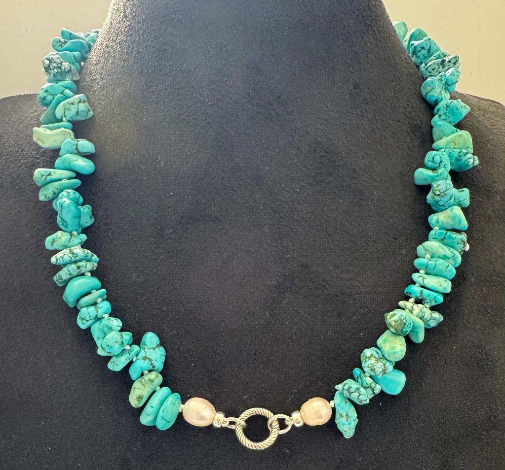 Turquoise stone necklace with pearl and silver clasp.