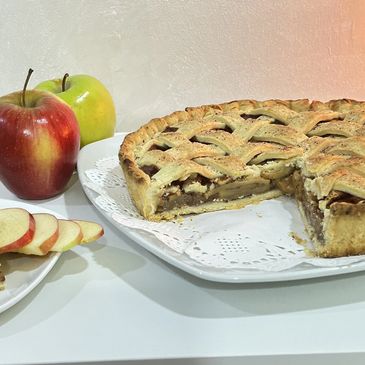 A delicious lattice apple pie with fresh red and green apples.