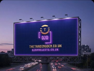 Billboard advertising The Trading Den and DJD Projects websites at dusk.