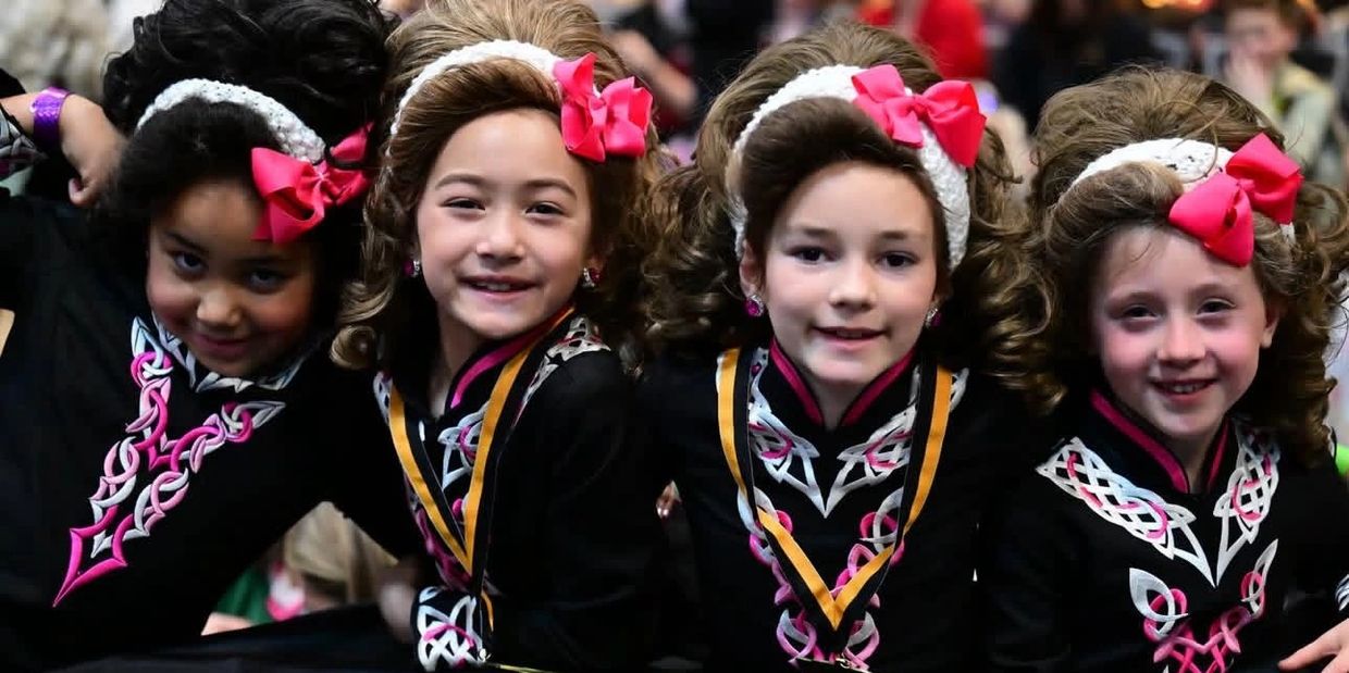 four young girls in kennelly school costume 
