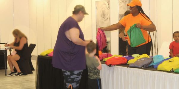Our Outreach & Events Coordinator, Latipha Silver-Pressley, handing out school supplies.