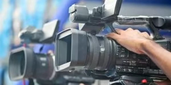 Professional video cameras being operated by camera operators.