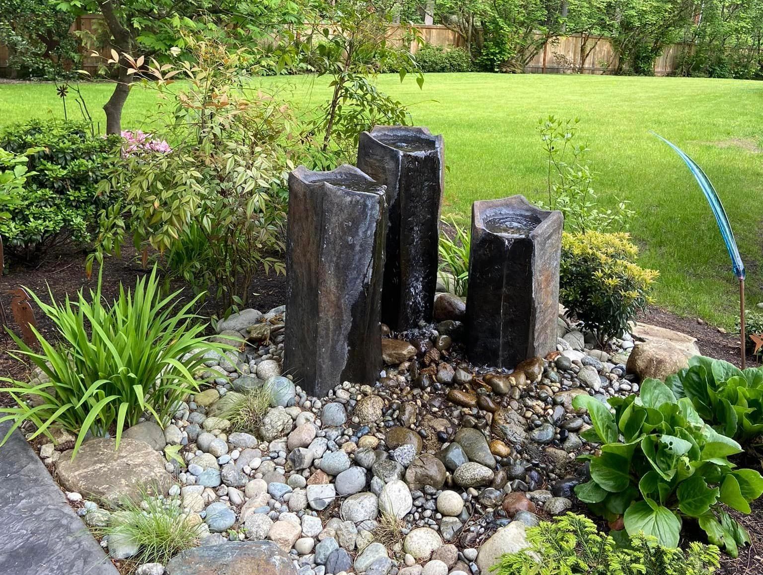 3 Column Water Feature with river rock basin.
