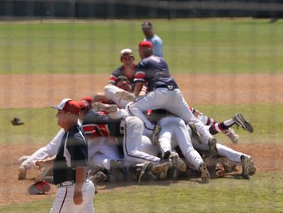 Baseball team dogpile after winning a national championship.