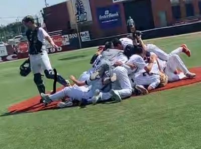 Baseball team celebrating a victory on the field.