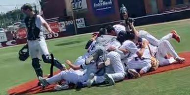 Baseball team celebrates after winning a  national tournament.