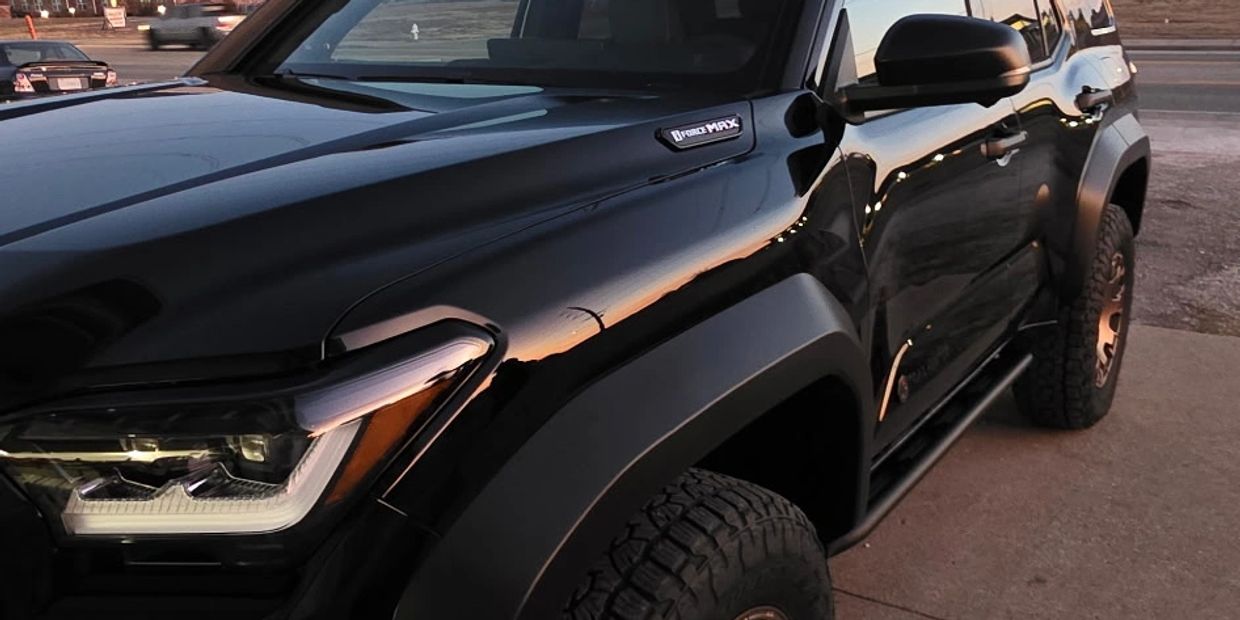 Black off-road vehicle parked on pavement.