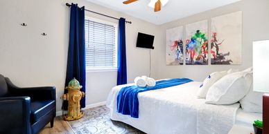Side view of bedroom decorated with superhero artwork and firehydrant