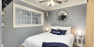 Bedroom with shiplap molding and captain's pillow