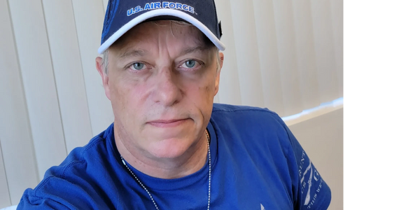 Man wearing U.S. Air Force cap and shirt.