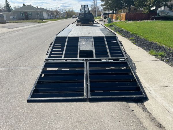 Monster Ramps on Prestige Mfg beaver tail deck over trailer. Rear hidden tool box.
