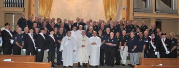 group of men standing with priests in a church 