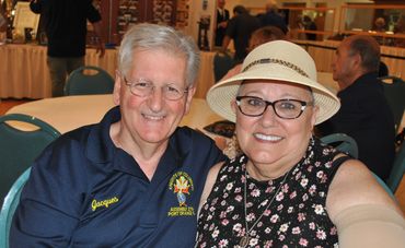 older couple smiling at a dinner event