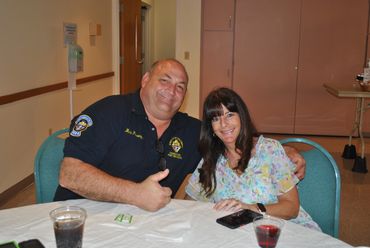 older man and younger woman posing for a picture