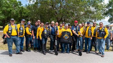 group of men with wearing yellow shirts and vests