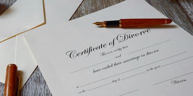 Certificate of Divorce on table with pen ready to sign