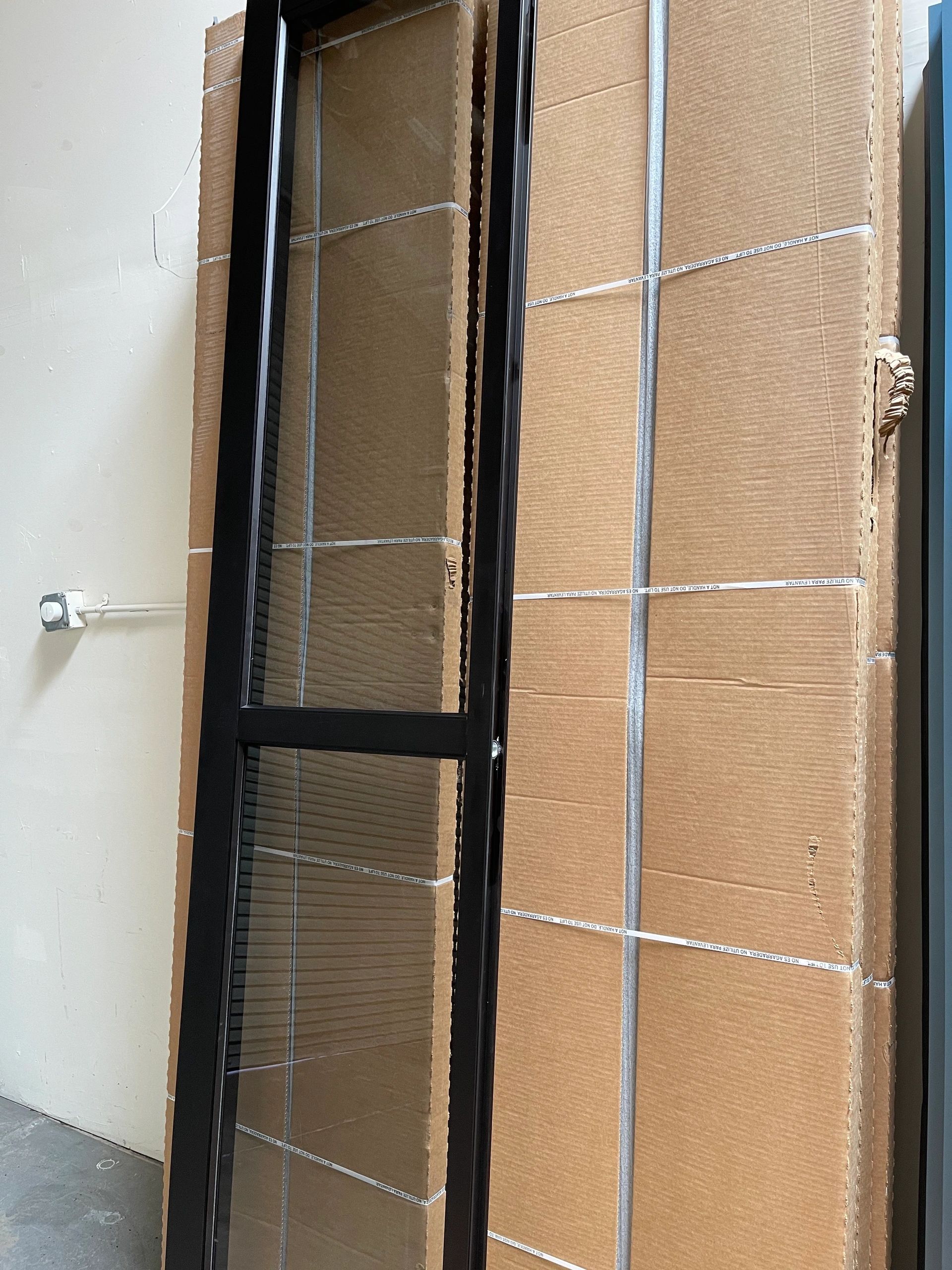 Full view (glass) single car garage door in stock.