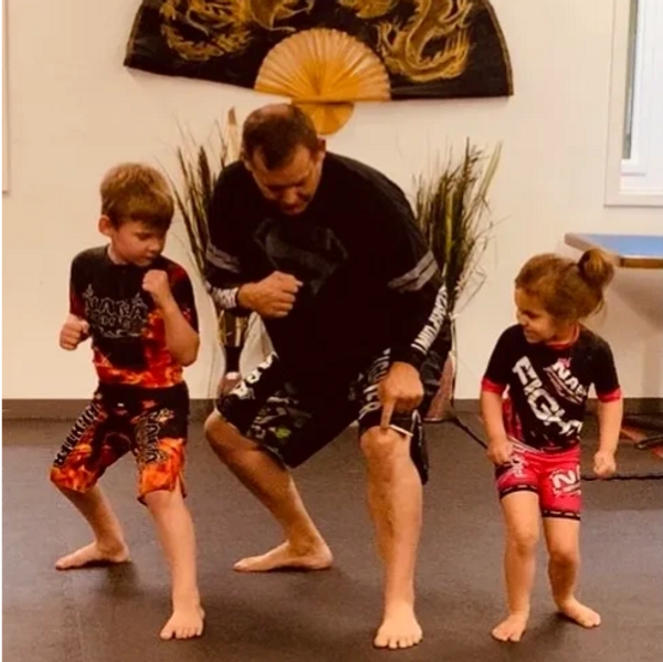 Kids and instructor participating in martial arts and mma class