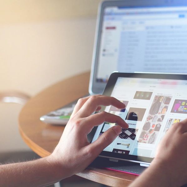 Social Media on A Tablet with Hands scrolling on it
