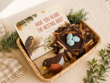Nest-themed basket with book and bird plush.