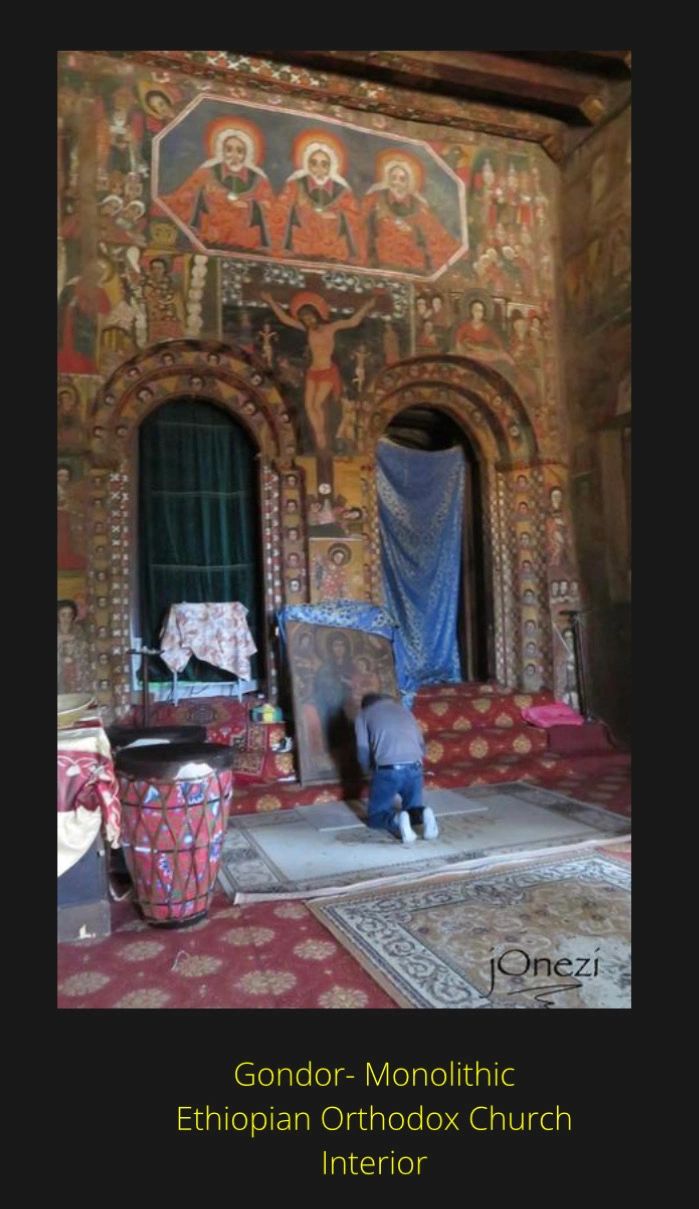 Interior of Gondor Monolithic Ethiopian Orthodox Church with intricate religious murals.