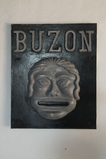 Vintage mailbox with a face design and the word BUZON 