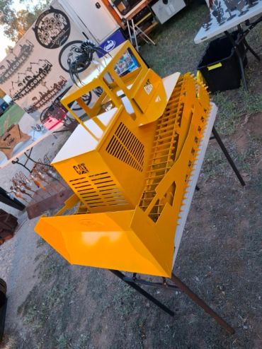 Yellow metal bulldozer model on a table.