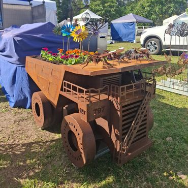 Rustic metal truck planter with flowers on top