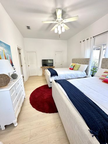 Guest bedroom on main floor with 2 queen beds and full bathroom.