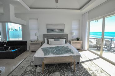 Primary bedroom with balcony and whirlpool spa