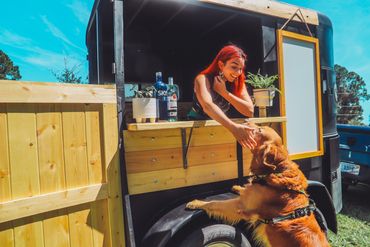 Alex serving up some doggie treats from her campfire trailer 