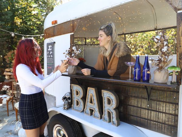 2 girls at a horse trailer mobile bar, campfire trailers 