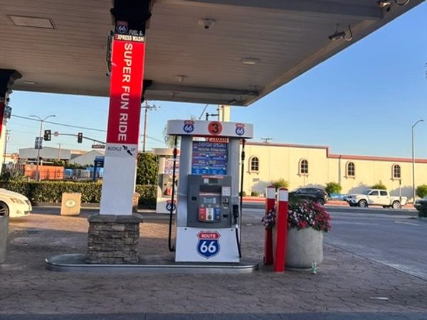 Gas station pump of Route 66 with a red sign.