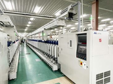High-tech textile manufacturing machine inside a factory.