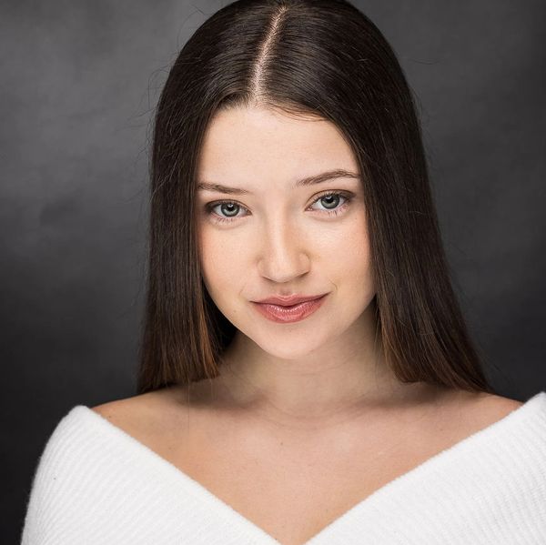 Portrait of a young woman with straight hair and a subtle smile.