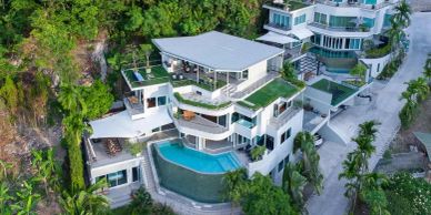 Luxury hillside mansion with modern architecture and infinity pool.