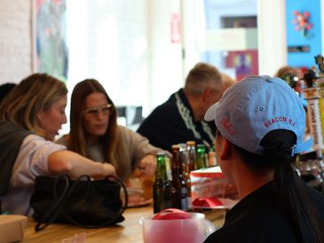 People socializing at a bar or restaurant table.