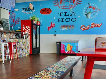 Colorful taco restaurant interior with vibrant decor.